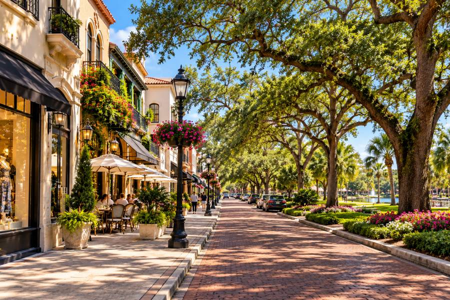 Brick-paved shopping street shaded by live oaks in the Orlando area