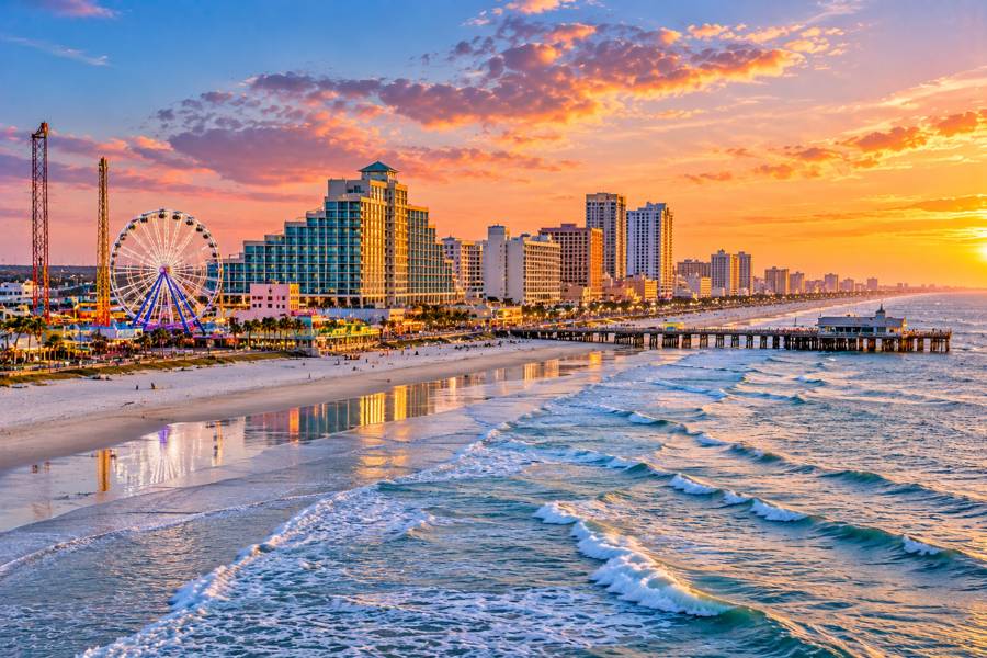 Daytona Beach shoreline, pier and Ferris wheel at sunset
